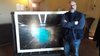L'artista Aqua Aura davanti a un'opera in mostra nella Palazzina Marfisa di Ferrara